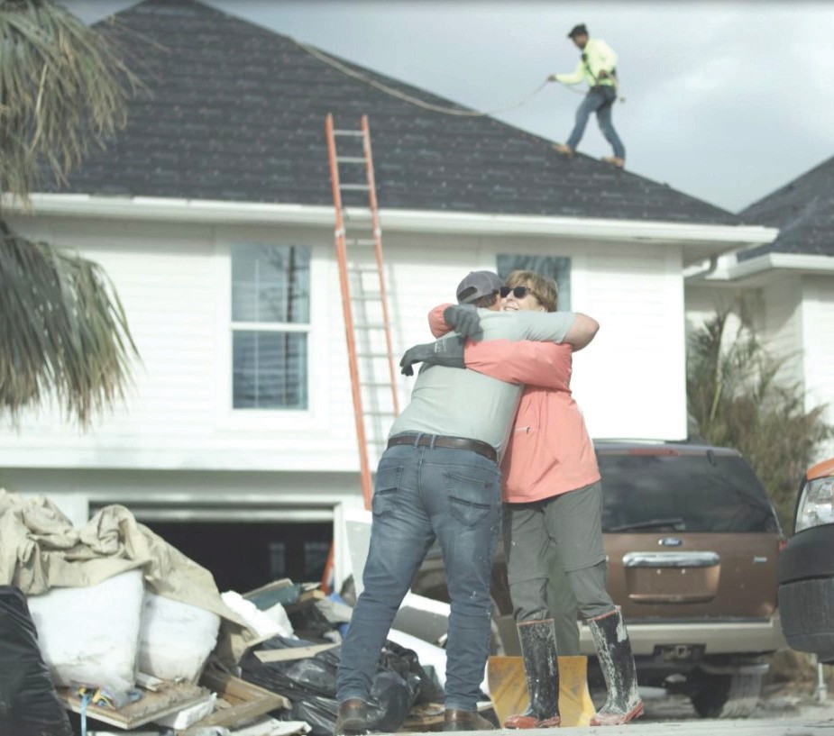 A homeowner greets a contractor from Crowther, whose team was on hand to make emergency repairs to a home in the aftermath of Hurricane Ian.