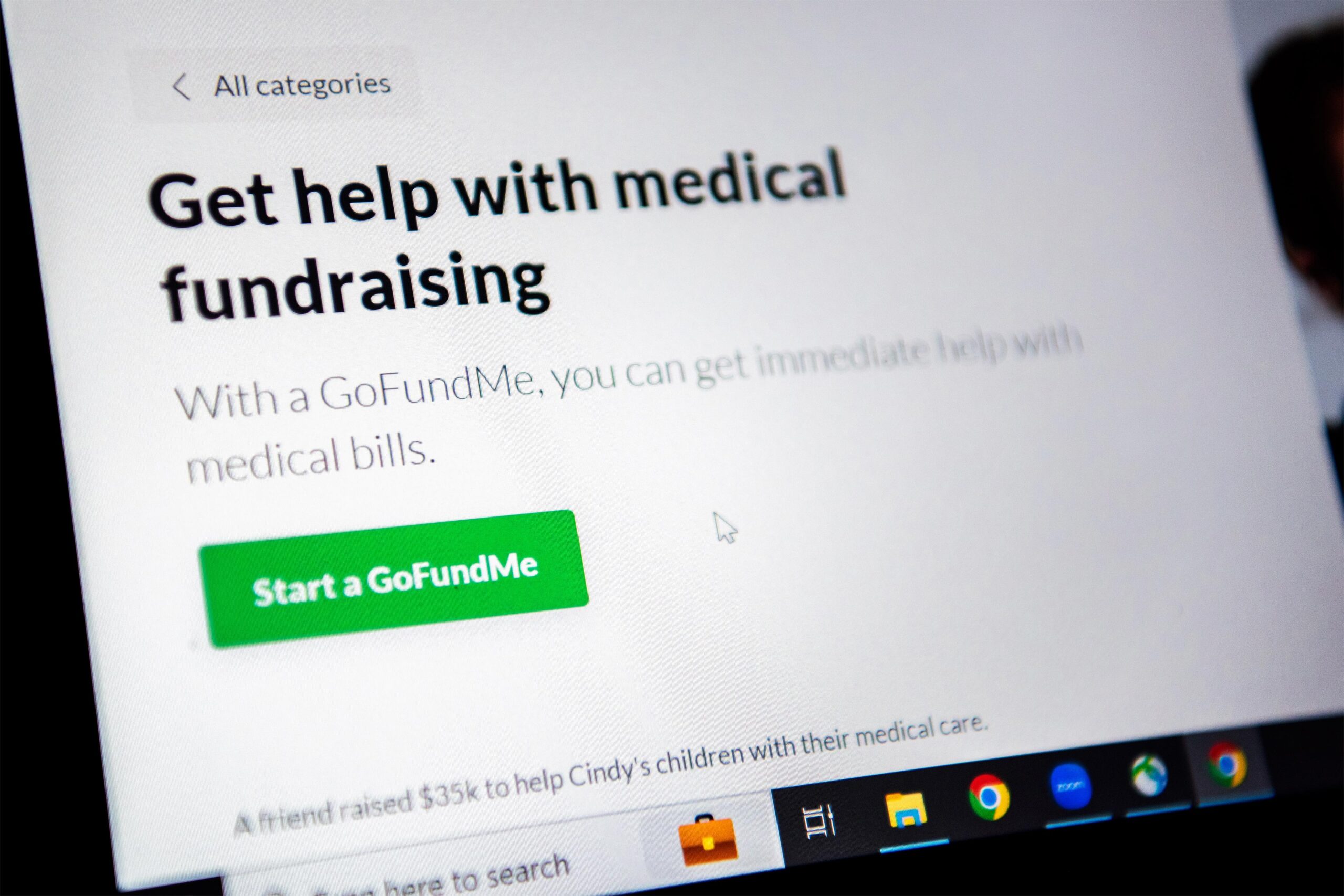 A photo of a laptop screen on GoFundMe's medical fundraising webpage. Text on the screen reads, 