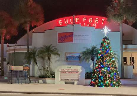 The Gulfport Casino at night, with a lit Saturnalia tree in front of it