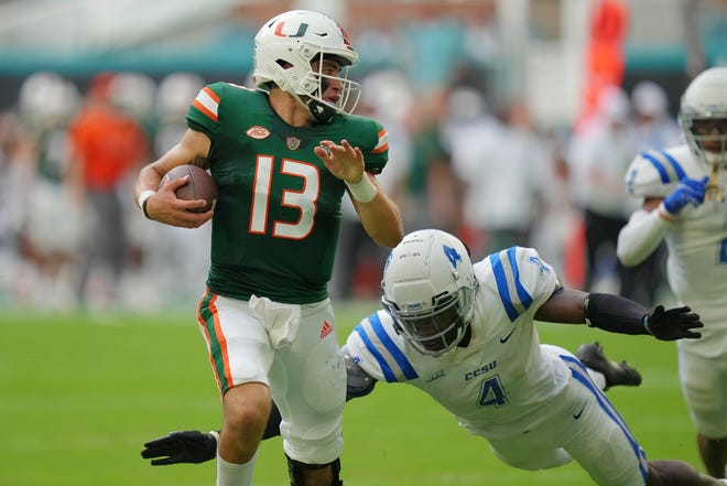 Miami quarterback Jake Garcia (13) evades a tackle during Hurricanes' victory over Central Connecticut State on Saturday at Hard Rock Stadium.  Jasen Vinlove-USA TODAY Sports